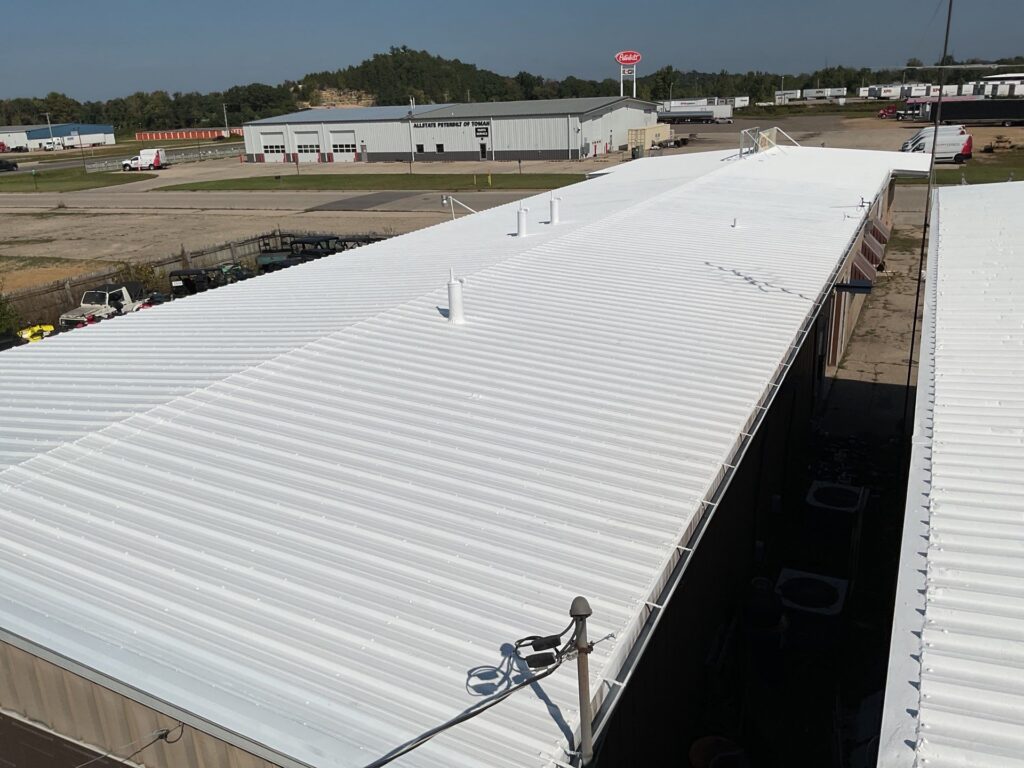 Bright white commercial metal roof on industrial building