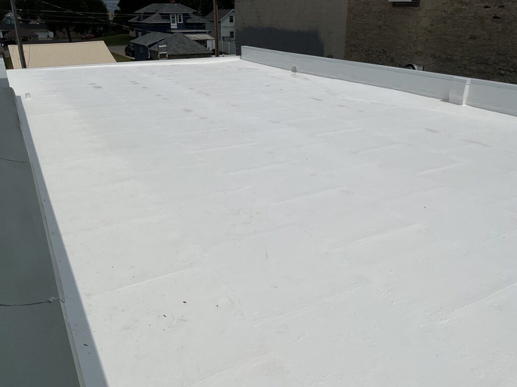 Newly installed white TPO flat roof on commercial building