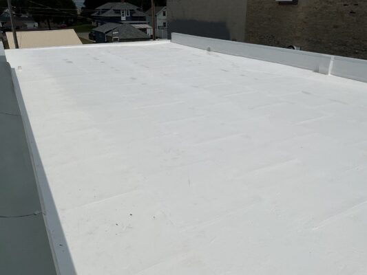 Newly installed white TPO flat roof on commercial building